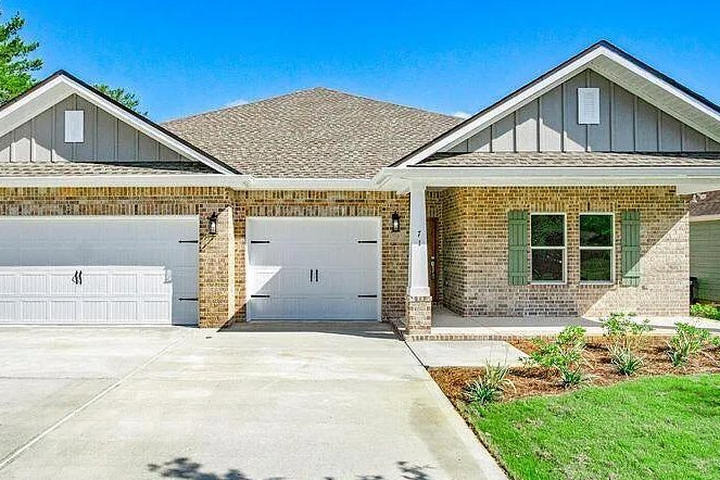 Brick home with twin gables and a three-car garage at 36 Laurie Dr, Fort Walton Beach